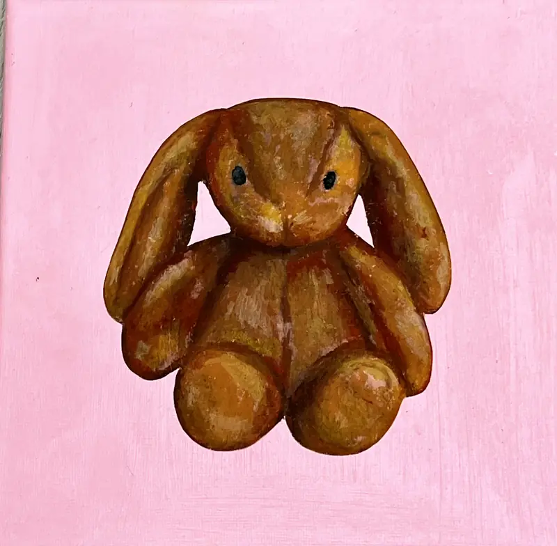 Toy rabbit painted on a pale pink canvas.